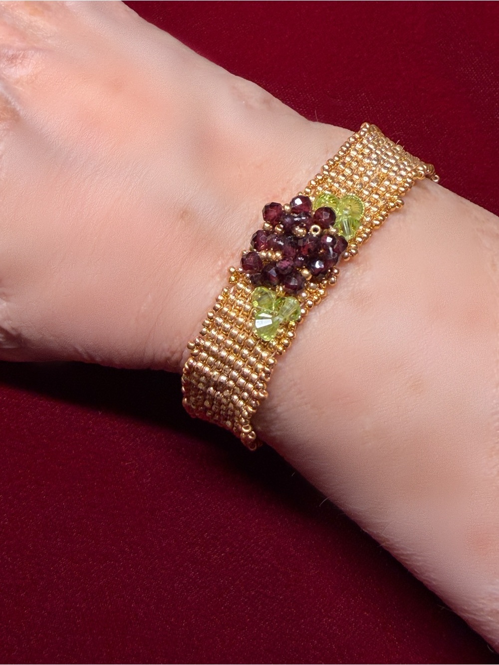 Hand woven gold color seed bead bracelet with garnet and crystal floral accent - Picture 1 of 8